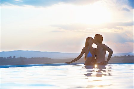 simsearch:649-08239088,k - Romantic couple kissing in outdoor swimming pool Stock Photo - Premium Royalty-Free, Code: 649-07560292