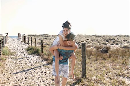 piggyback at beach - Man giving young woman piggyback, Port Melbourne, Melbourne, Australia Stock Photo - Premium Royalty-Free, Code: 649-07560441