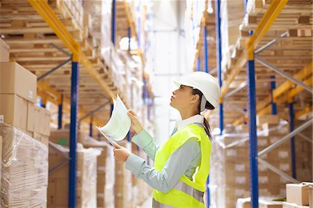 Female warehouse worker checking stock Stock Photo - Premium Royalty-Free, Code: 649-07585255