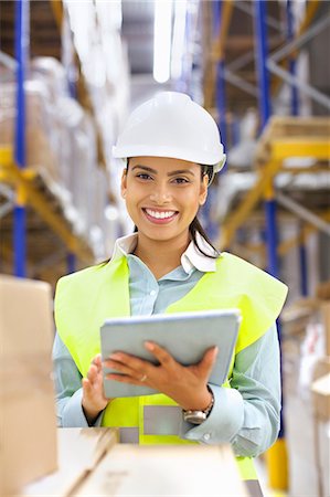 simsearch:649-07239373,k - Young woman with digital tablet in distribution warehouse Stock Photo - Premium Royalty-Free, Code: 649-07585260