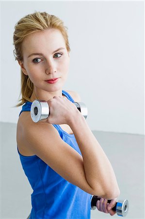 Young woman lifting weights Stock Photo - Premium Royalty-Free, Code: 649-07585516