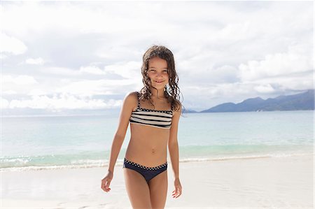 swimsuits for girls - Girl standing on beach in Seychelles Stock Photo - Premium Royalty-Free, Code: 649-07585546