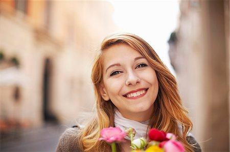 Smiling young woman with a bunch of flowers Stock Photo - Premium Royalty-Free, Code: 649-07585578