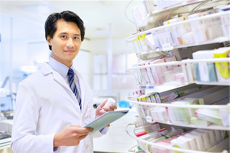 electronics computer technology - Portrait of male pharmacist stock taking in pharmacy Stock Photo - Premium Royalty-Free, Code: 649-07596150