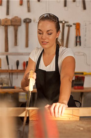 sawing - Carpenter sawing wood Stock Photo - Premium Royalty-Free, Code: 649-07596295