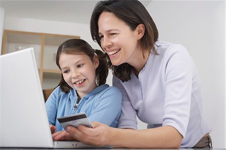 Mother and young daughter shopping online Stock Photo - Premium Royalty-Free, Code: 649-07596356