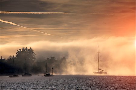 scenic sailboat - Mist and yachts on Lake Maggiore, Piemonte, Novara, Italy Foto de stock - Sin royalties Premium, Código: 649-07596466
