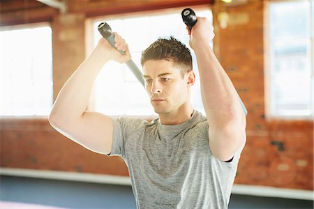 Man lifting weights in gymnasium Stock Photo - Premium Royalty-Free, Code: 649-07596657
