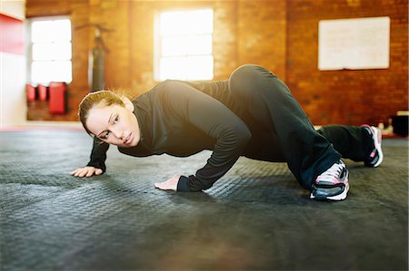 Woman doing stretching exercise in gym Stock Photo - Premium Royalty-Free, Code: 649-07648173