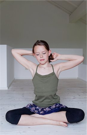 Portrait of unhappy twelve year old girl sitting on attic floor Stock Photo - Premium Royalty-Free, Code: 649-07648279