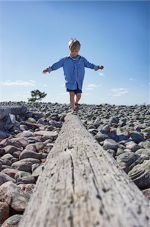 drift wood - Boy balancing on log on beach Stock Photo - Premium Royalty-Free, Code: 649-07648397