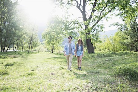 romantic couple holding hands - Young couple strolling in sunlight, Piemonte, Italy Stock Photo - Premium Royalty-Free, Code: 649-07648489