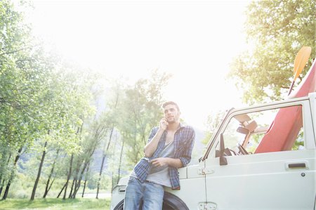 simsearch:649-07648247,k - Young man leaning against off road vehicle Stock Photo - Premium Royalty-Free, Code: 649-07648540