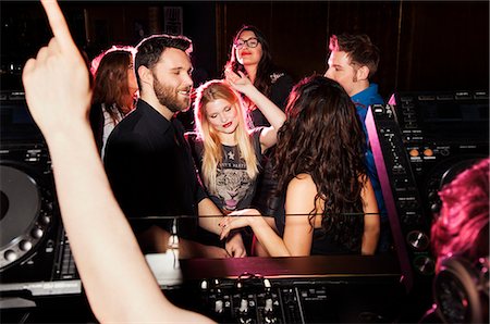 Group of young men and women dancing in front of  DJ in nightclub Stock Photo - Premium Royalty-Free, Code: 649-07648582