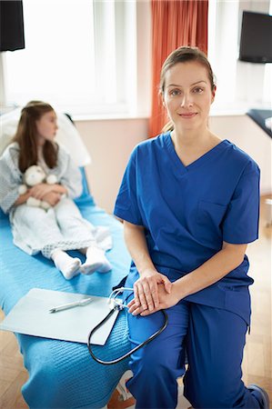 simsearch:649-07709952,k - Nurse sitting on end of patient's bed Stock Photo - Premium Royalty-Free, Code: 649-07709946