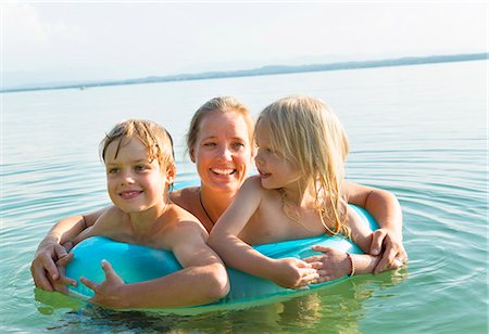 Mother with daughter and son in inflatable ring, Lake Starnberg, Bavaria, Germany Stock Photo - Premium Royalty-Free, Code: 649-07710323