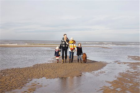 dog and boys playing image - Mid adult parents with son, daughter and dog strolling on beach, Bloemendaal aan Zee, Netherlands Stock Photo - Premium Royalty-Free, Code: 649-07710721