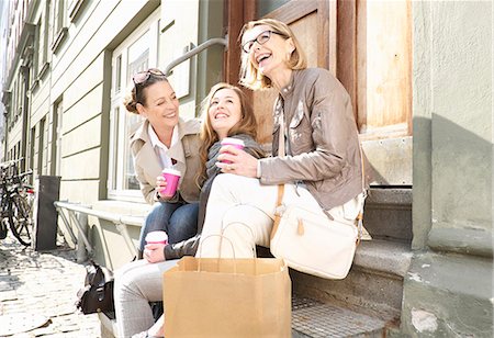 family outdoors active - Three generation females drinking takeaway coffee on street Stock Photo - Premium Royalty-Free, Code: 649-07710766