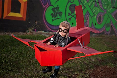 simsearch:649-07761212,k - Boy wearing flying goggles running in toy airplane in park at night Stock Photo - Premium Royalty-Free, Code: 649-07710804