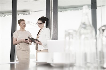 simsearch:649-07736470,k - Two young businesswomen having meeting in conference room Stock Photo - Premium Royalty-Free, Code: 649-07736439