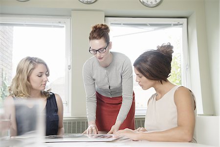 simsearch:649-07736470,k - Three businesswomen looking at blueprint in office Stock Photo - Premium Royalty-Free, Code: 649-07736459