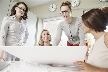 simsearch:649-07736470,k - Four businesswomen looking at blueprint in office Stock Photo - Premium Royalty-Free, Code: 649-07736460