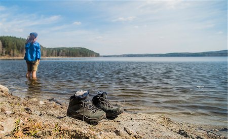 simsearch:614-07240106,k - Mid adult female hiker taking a paddle in lake Stock Photo - Premium Royalty-Free, Code: 649-07736823