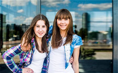 simsearch:649-07736862,k - Portrait of two smiling young women in front of glass fronted office building Stock Photo - Premium Royalty-Free, Code: 649-07736845