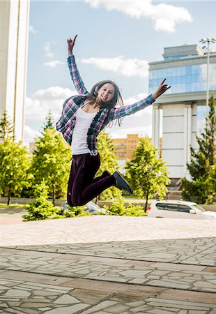 simsearch:649-08117852,k - Young woman jumping mid air in city Foto de stock - Sin royalties Premium, Código: 649-07736856