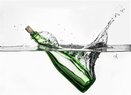 simsearch:614-06813723,k - Surface level view of green bottle splashing into clear water Stock Photo - Premium Royalty-Free, Code: 649-07736867