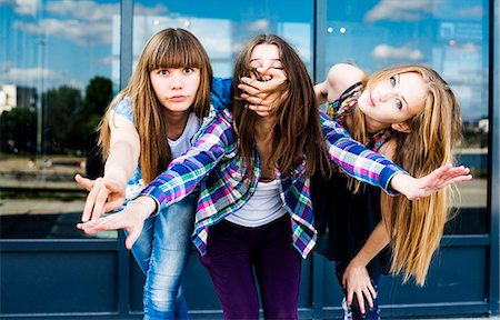 simsearch:649-07736862,k - Three young women in a row leaning forward and covering mouth Stock Photo - Premium Royalty-Free, Code: 649-07736861