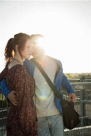 simsearch:649-07736862,k - Romantic young couple leaning against fence on rooftop Stock Photo - Premium Royalty-Free, Code: 649-07736963