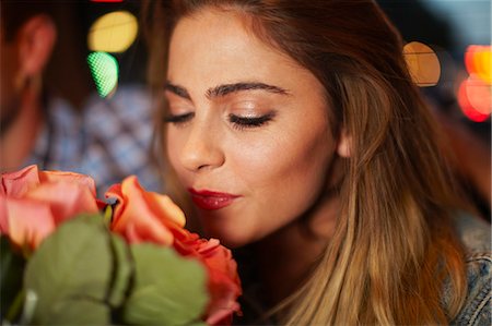 simsearch:649-07118859,k - Young woman with boyfriend smelling roses in city taxi at night Stock Photo - Premium Royalty-Free, Code: 649-07737018