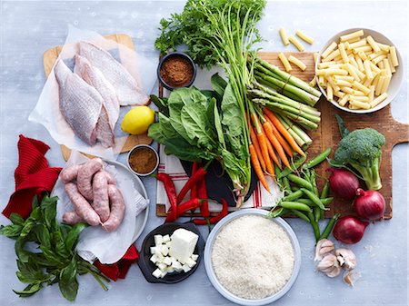 simsearch:400-06864386,k - Overhead view of fish, pork sausage, feta and selection of fresh organic herbs and vegetable Stock Photo - Premium Royalty-Free, Code: 649-07737046