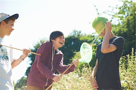 Three boys playing with fishing nets Stock Photo - Premium Royalty-Free, Code: 649-07760849