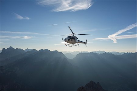 Helicopter on scenic flight at sunrise, Alleghe, Dolomites, Italy Stock Photo - Premium Royalty-Free, Code: 649-07760927