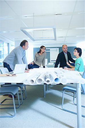 rolled up (closely coiled) - Group of business people discussing plans Stock Photo - Premium Royalty-Free, Code: 649-07761035