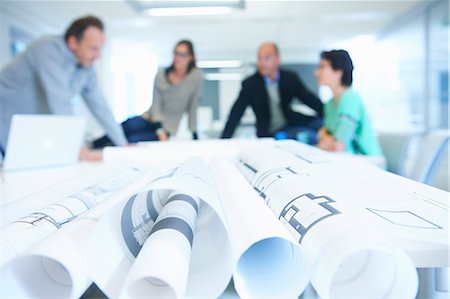 paper rolls - Group of business people discussing plans Stock Photo - Premium Royalty-Free, Code: 649-07761036