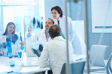 Group of doctors looking at x-rays Stock Photo - Premium Royalty-Free, Code: 649-07761045