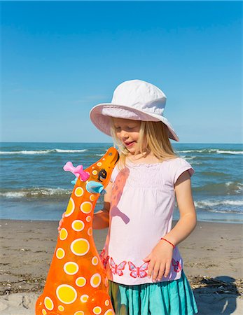 simsearch:649-07761212,k - Girl holding up inflatable giraffe, Caleri Beach, Veneto, Italy Stock Photo - Premium Royalty-Free, Code: 649-07761151