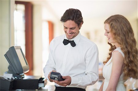 Waiter and female customer using credit card machine in restaurant Stock Photo - Premium Royalty-Free, Code: 649-07761226