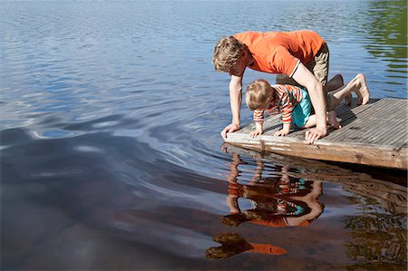simsearch:649-07437107,k - Father and son looking down into lake from pier, Somerniemi, Finland Stock Photo - Premium Royalty-Free, Code: 649-07761257