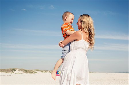 simsearch:649-07585546,k - Mid adult mother carrying son on beach, Cape Town, Western Cape, South Africa Stock Photo - Premium Royalty-Free, Code: 649-07804097