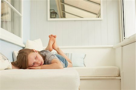 front porch - Sullen girl lying on holiday apartment seat Stock Photo - Premium Royalty-Free, Code: 649-07804099