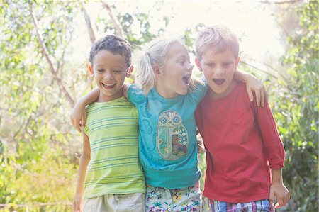 simsearch:649-07804176,k - Three children in garden with arms around each other Stock Photo - Premium Royalty-Free, Code: 649-07804150
