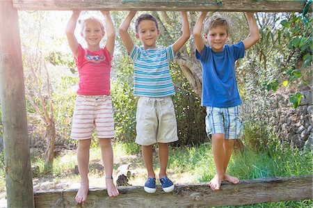 simsearch:649-07804176,k - Three children in garden standing on fence Stock Photo - Premium Royalty-Free, Code: 649-07804152