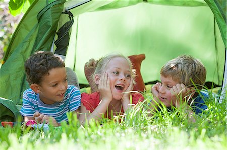 simsearch:649-07804176,k - Three children lying chatting in garden tent Stock Photo - Premium Royalty-Free, Code: 649-07804169