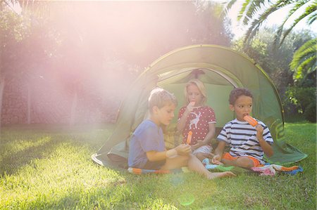 simsearch:649-07804176,k - Three children eating ice lollies in garden tent Stock Photo - Premium Royalty-Free, Code: 649-07804175