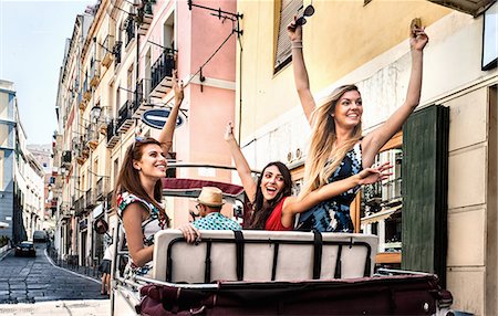 Three young women in open back seat of Italian taxi, Cagliari, Sardinia, Italy Stock Photo - Premium Royalty-Free, Code: 649-07804267