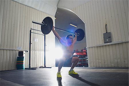 simsearch:693-08126938,k - Crossfitter lifting barbell in gym Stock Photo - Premium Royalty-Free, Code: 649-07804602